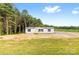 Classic exterior design with mature trees providing ample shade and curb appeal at 977 Myers Mill Rd, Olin, NC 28660