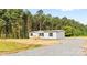 Beautiful home with a manicured lawn and a picturesque tree line in the background at 977 Myers Mill Rd, Olin, NC 28660