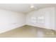 A simple room design with white paneled walls, a window, and a paint-splattered floor at 10 Cedarvilla Dr, Rock Hill, SC 29730