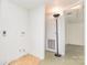 Unfinished laundry room with aged wall panels and weather trim and an open door with an overhead lamp at 10 Cedarvilla Dr, Rock Hill, SC 29730