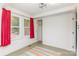 Well-lit room with bright walls, two windows, red curtains, closet, and accent rug at 10 Cedarvilla Dr, Rock Hill, SC 29730