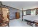 Spacious bedroom features floral wallpaper, wood trim, and bright natural light from large windows at 10215 Balmoral Cir, Charlotte, NC 28210