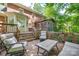 Beautiful deck area with a table and seating, along with entrances to both the house and a screened-in porch at 10215 Balmoral Cir, Charlotte, NC 28210