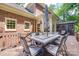 Spacious deck with outdoor table, chairs, and an umbrella in a brick house backyard near a screened in porch at 10215 Balmoral Cir, Charlotte, NC 28210