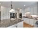 The kitchen features white cabinets, granite counters, and an island with seating and a black fridge at 10215 Balmoral Cir, Charlotte, NC 28210