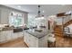 The kitchen features an island with seating, granite counters, and a large window to the backyard at 10215 Balmoral Cir, Charlotte, NC 28210