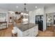 The kitchen features an island with seating, granite counters, and access to the wooden staircase at 10215 Balmoral Cir, Charlotte, NC 28210