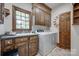 This is a well-lit laundry room with a sink, washer, dryer, and plenty of cabinet space at 10215 Balmoral Cir, Charlotte, NC 28210