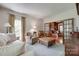 Comfortable living room with plush seating, large windows, and view into sunroom at 10215 Balmoral Cir, Charlotte, NC 28210