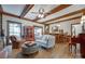 Inviting living room with exposed beam ceiling, hardwood floors, built-in bar, and ample seating at 10215 Balmoral Cir, Charlotte, NC 28210