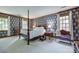 This is a spacious main bedroom with a four-poster bed, nightstands, and floral wallpaper at 10215 Balmoral Cir, Charlotte, NC 28210