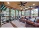 Bright sunroom with wood ceiling, lots of windows, tile flooring, and comfortable seating for relaxing and enjoying the view at 10215 Balmoral Cir, Charlotte, NC 28210