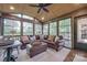 Lovely sunroom with vaulted wood ceilings, large windows, and comfortable seating with an attached patio at 10215 Balmoral Cir, Charlotte, NC 28210