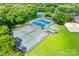 Aerial view of community tennis courts and lush greenery with an equipment shed at 10215 Balmoral Cir, Charlotte, NC 28210