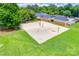 Aerial view of community sand volleyball court on lush lawn with shade trees at 10215 Balmoral Cir, Charlotte, NC 28210