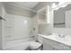 This bathroom has a white tub and shower, toilet, vanity, and mirrored cabinet at 107 S Branch St, Monroe, NC 28112