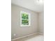 This bedroom features neutral paint, carpet and trim, with a window offering natural light at 107 S Branch St, Monroe, NC 28112