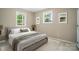 Serene bedroom featuring soft lighting, neutral paint, and carpeted floors at 107 S Branch St, Monroe, NC 28112