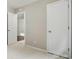 This bedroom has neutral paint, carpet and trim, with 2 doors and an open closet at 107 S Branch St, Monroe, NC 28112