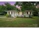 Charming single-story home featuring manicured landscaping and a classic white exterior at 107 S Branch St, Monroe, NC 28112