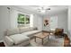 Bright living room featuring hardwood floors, neutral paint, and a large window with natural light at 107 S Branch St, Monroe, NC 28112
