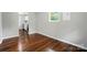 Sun-filled living room featuring hardwood floors, neutral paint and views into the kitchen at 107 S Branch St, Monroe, NC 28112
