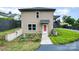 This backyard features a cement pathway, small plants, and partial view of the home's exterior at 1125 Bethel Rd, Charlotte, NC 28208
