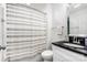 This bathroom features a shower with a white curtain and a black vanity with a mirror at 1125 Bethel Rd, Charlotte, NC 28208