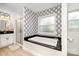 Luxurious bathroom with patterned wallpaper, a soaking tub, and a glass-enclosed shower at 1125 Bethel Rd, Charlotte, NC 28208