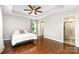 Spacious bedroom features a tray ceiling, a ceiling fan, and an en-suite bathroom at 1125 Bethel Rd, Charlotte, NC 28208