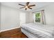 This bedroom features hardwood floors, a modern ceiling fan, and a window with natural light at 1125 Bethel Rd, Charlotte, NC 28208