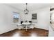 Bright dining area offers a cozy bench seating, lots of natural light and hardwood floors at 1125 Bethel Rd, Charlotte, NC 28208