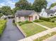 Attractive home featuring a well-maintained lawn, bright front door, and a detached garage at 1125 Bethel Rd, Charlotte, NC 28208