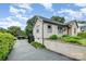 Charming home featuring a low brick and stucco fence, tasteful landscaping, and a detached garage at 1125 Bethel Rd, Charlotte, NC 28208