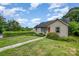 Charming house with a well manicured lawn and established trees adding to the curb appeal at 1125 Bethel Rd, Charlotte, NC 28208