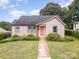 Charming single-story home with a well-manicured lawn, inviting walkway, and a bright front door at 1125 Bethel Rd, Charlotte, NC 28208