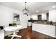 Open kitchen and dining area featuring stylish pendant lighting, white cabinetry, and stainless steel appliances at 1125 Bethel Rd, Charlotte, NC 28208