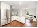 Bright kitchen features stainless steel appliances, white cabinets, granite countertops and a cozy breakfast nook at 1125 Bethel Rd, Charlotte, NC 28208