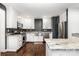 Modern kitchen featuring stainless steel appliances, white cabinets, and granite countertops at 1125 Bethel Rd, Charlotte, NC 28208