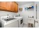 Practical laundry room equipped with a washer, dryer, sink, and storage cabinets at 1125 Bethel Rd, Charlotte, NC 28208