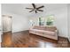 Bright living room with hardwood floors, a ceiling fan, and a comfortable sofa offering plenty of space at 1125 Bethel Rd, Charlotte, NC 28208