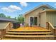 Outdoor deck area perfect for entertaining with a grill, seating, and direct access to inside through sliding glass doors at 1209 Rainbow Dr, Kannapolis, NC 28081