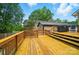A large deck with wood finish, featuring access to a spacious backyard with potential for outdoor entertainment at 1209 Rainbow Dr, Kannapolis, NC 28081