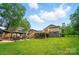 Expansive backyard featuring a gazebo, deck with stairs, and lush green lawn at 1209 Rainbow Dr, Kannapolis, NC 28081