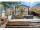 Backyard with a stone patio, rustic wood steps, and wrought iron bench seating area surrounded by privacy fence at 1209 Rainbow Dr, Kannapolis, NC 28081