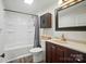 Clean bathroom featuring a shower and tub, dark wood vanity, and modern fixtures at 1209 Rainbow Dr, Kannapolis, NC 28081