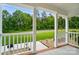 View from the cozy covered front porch with white columns and view of the landscaped yard at 1209 Rainbow Dr, Kannapolis, NC 28081