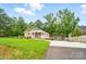 Inviting home with a well-manicured lawn, covered porch, and detached garage in the back at 1209 Rainbow Dr, Kannapolis, NC 28081