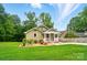 Charming home with a covered front porch, landscaped yard, and lush green lawn at 1209 Rainbow Dr, Kannapolis, NC 28081