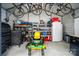 Well-organized garage with ample storage, lawn equipment, tools, and a large refrigerator at 1209 Rainbow Dr, Kannapolis, NC 28081